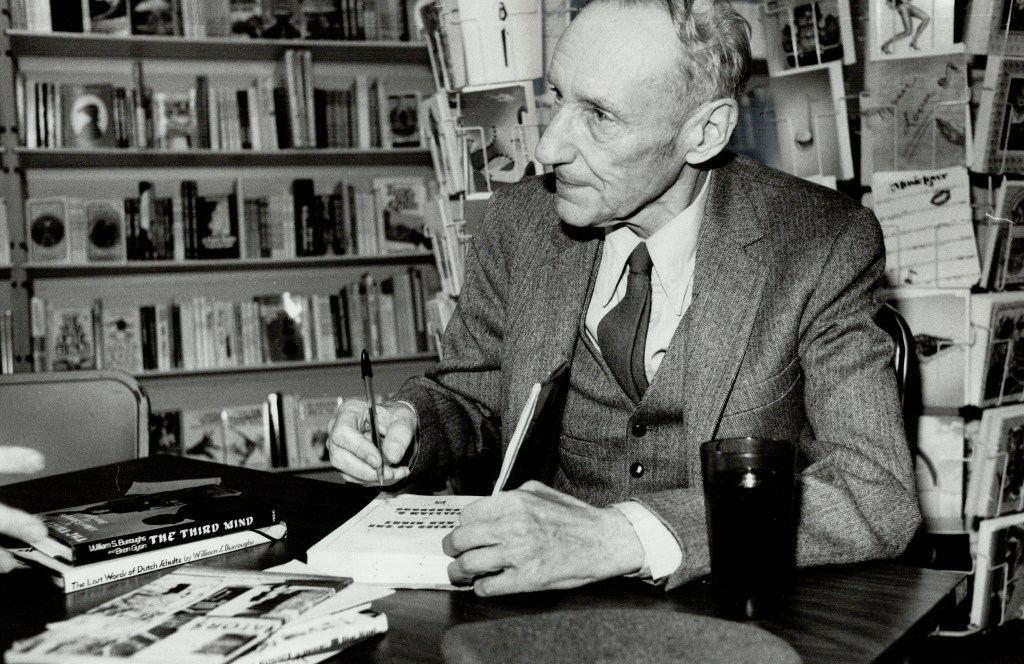 uthor William Burroughs, in Toronto to give readings at The Edge, autographs one of his books.