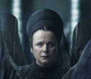 Emily Watson in Dune: Prophecy. She's sat in an all black dress and veil standing at the centre of several women with their dark veils conceiling their faces.