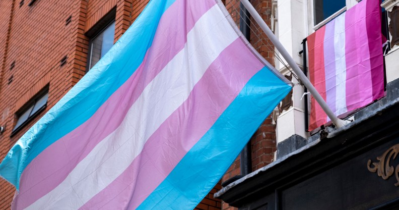 trans flag hanging outside of a building in Soho