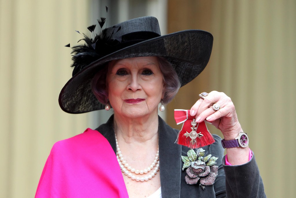 April Ashley, the first Briton to undergo gender confirmation surgery, poses with her Member of the British Empire (MBE) medal following an Investiture ceremony at Buckingham Palace in central London on December 13, 2012. AFP PHOTO/POOL/SEAN DEMPSEY (Photo credit should read SEAN DEMPSEY/AFP via Getty Images)