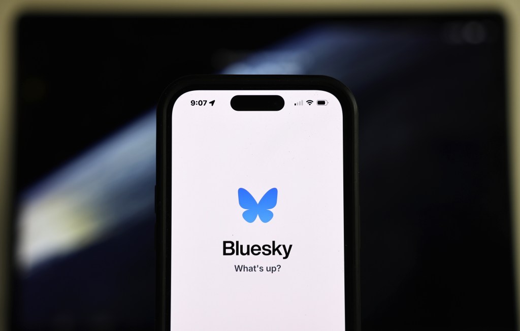 In this photo illustration, the Bluesky logo is displayed on a cell phone