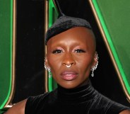 Cynthia Erivo attends the "Wicked: Part One" European Premiere . wearing dark green velvet dress and hat with multiple silver earings.