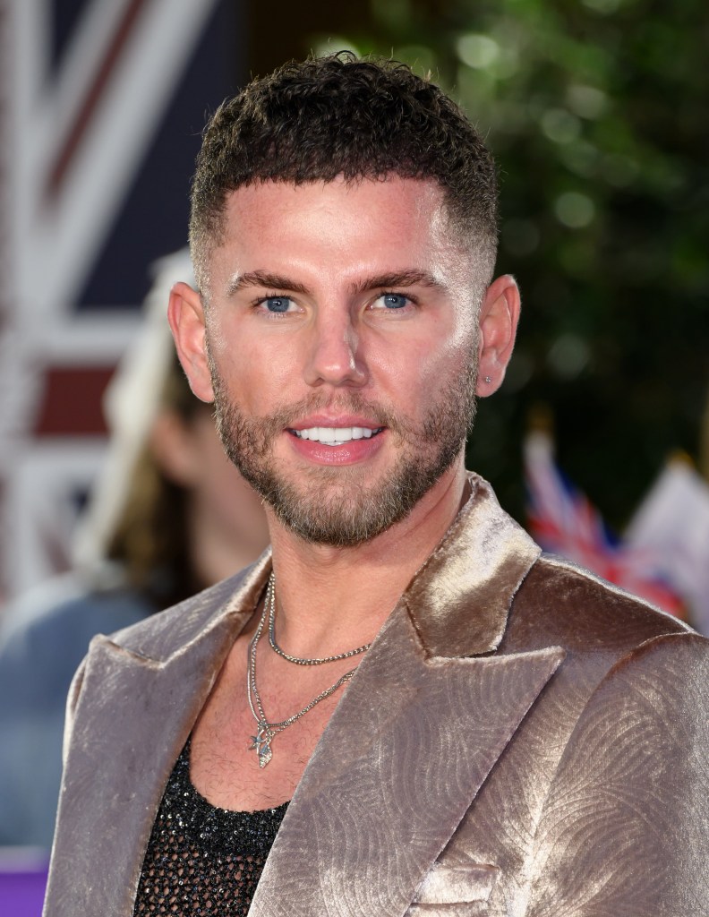 Dean McCullough attends The Pride of Britain Awards in a mesh black vest and golden velvet suit