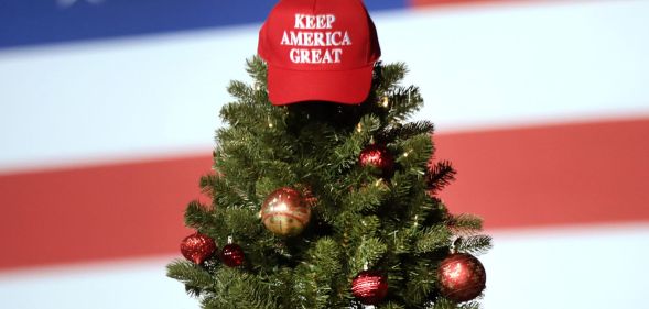 Trump Store Christmas range - Christmas MAGA hat sat atop a Christmas tree