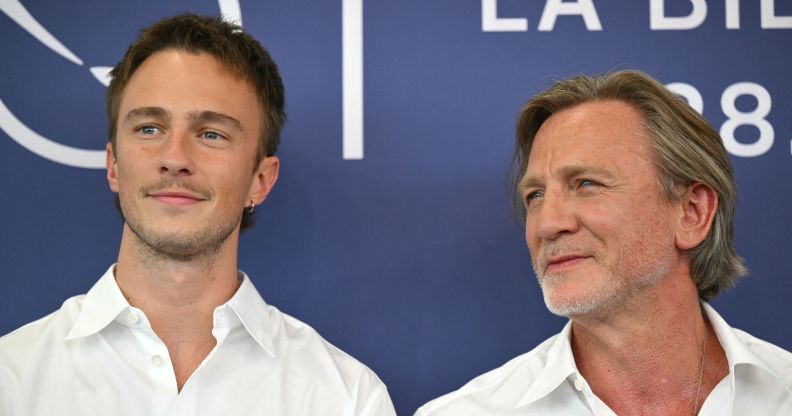 Drew Starkey and Daniel Craig on a red carpet looking away from the camera