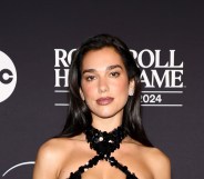 Dua Lipa attends the 2024 Rock & Roll Hall Of Fame Induction Ceremony in a black sequin halter neck dress