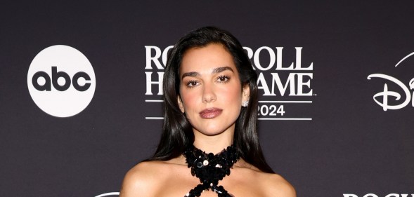 Dua Lipa attends the 2024 Rock & Roll Hall Of Fame Induction Ceremony in a black sequin halter neck dress