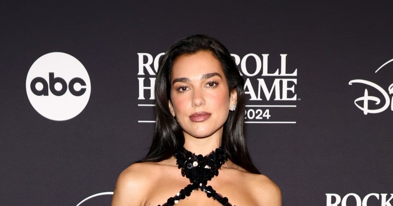 Dua Lipa attends the 2024 Rock & Roll Hall Of Fame Induction Ceremony in a black sequin halter neck dress