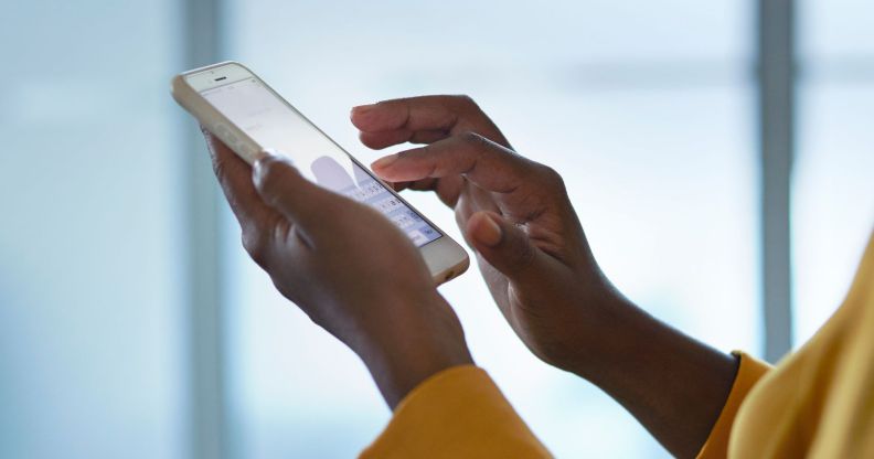 A person scrolls through their phone.