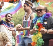 Danny Devito wearing a feather boa at 2016 LA Pride