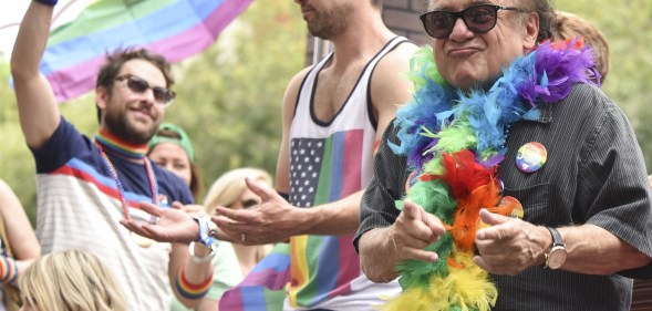 Danny Devito wearing a feather boa at 2016 LA Pride