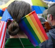 A Parade participant wears a US and LGBT flags in her hair.