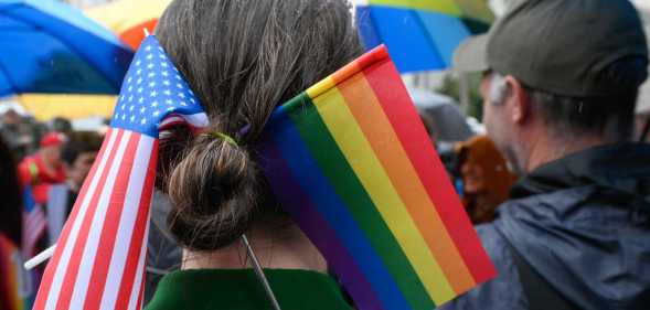 A Parade participant wears a US and LGBT flags in her hair.