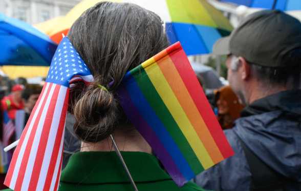 A Parade participant wears a US and LGBT flags in her hair.