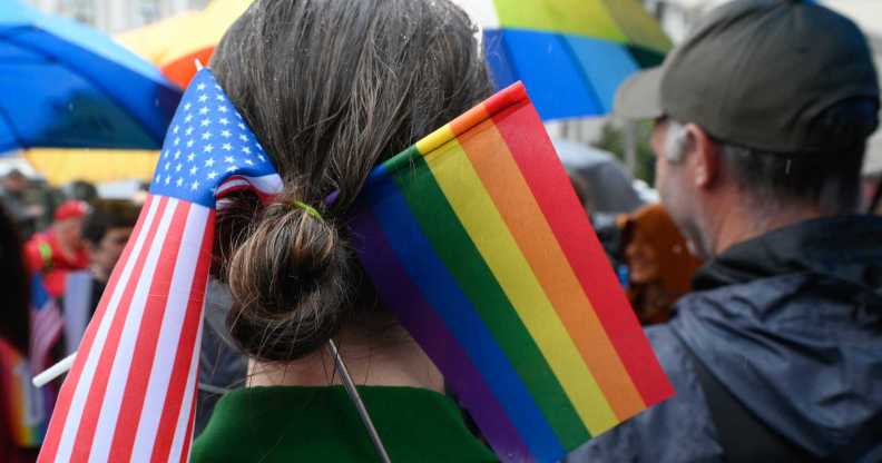 A Parade participant wears a US and LGBT flags in her hair.