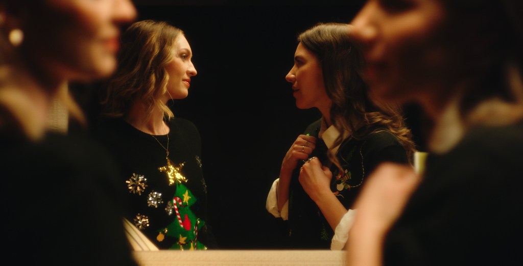 Looking for Her: two women in christmas jumpers chatting