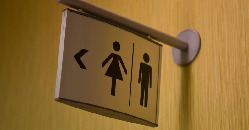 A sign leading to gendered toilets.