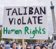 Person holds up a placard reading "Taliban violate human rights" at a protest against the Taliban in London