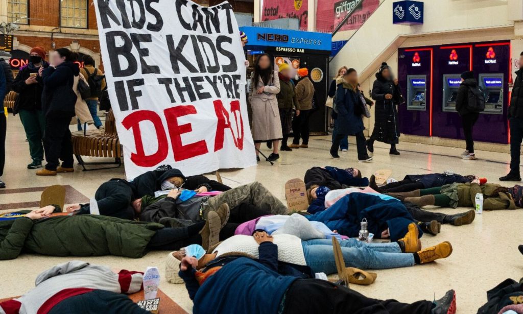 A group of trans young people staging a die-in at London Victoria Station. 