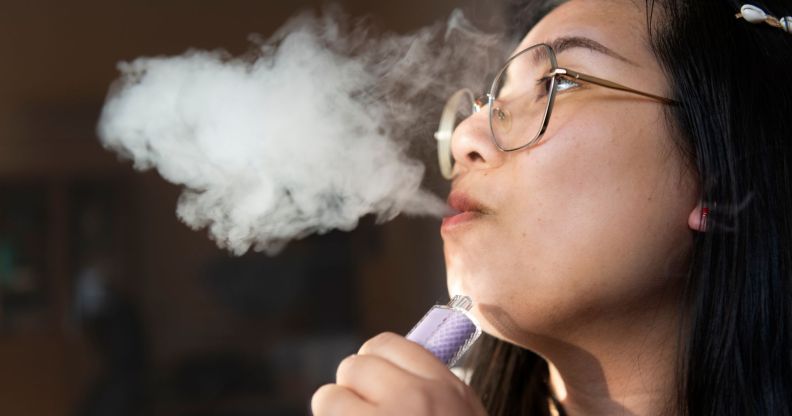 Stock image of a woman with a vape