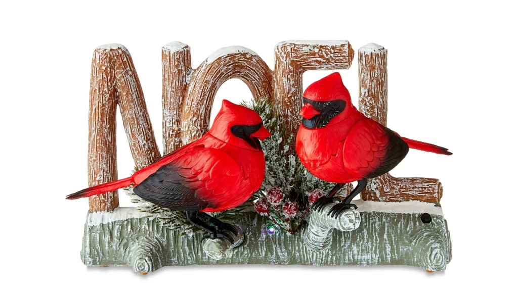 Walmart’s gay Cardinal ornament: a Noel sign on a branch with two red cardinals perched