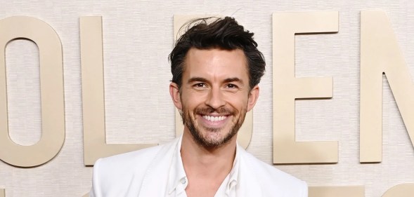 Jonathan Bailey on a white suit smiling