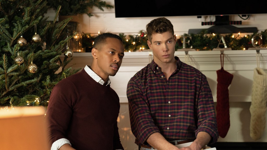 A Jenkins Family Christmas; a Black man and a white man stood by a christmas tree looking confused