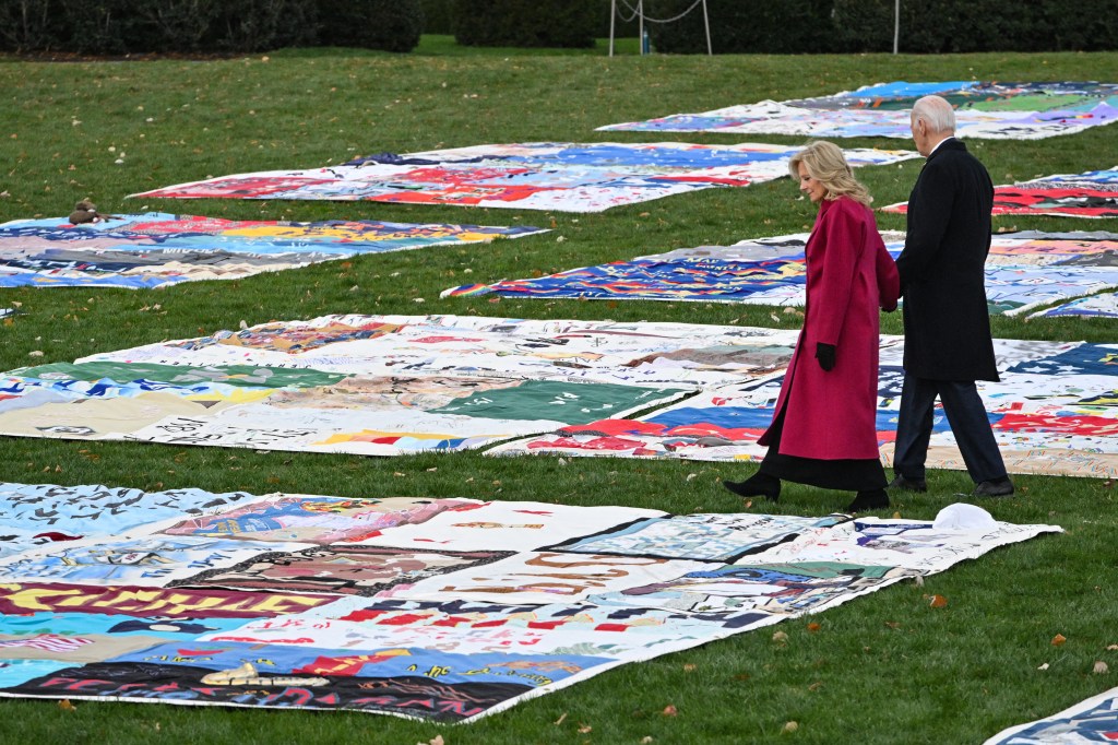 US president Joe Biden and US First Lady Jill Biden walk through sections of the AIDS Memorial Quilt laid out on the South Lawn of the White House.  