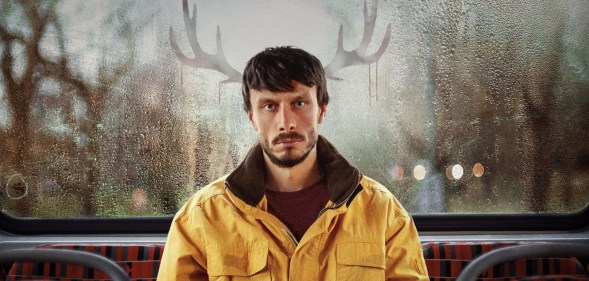 Baby Reindeer creator Richard Gadd sitting on the bus with antlers on the window from condensation