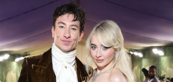 Barry Keoghan and Sabrina Carpenter pose together smiling in May 2024