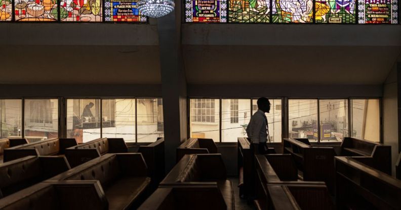 A man walks through the bench of the Methodist Church of the Trinity in Lagos on February 19, 2023 (Getty)