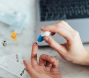 Someone performing a self-blood test on themselves.