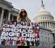 Paris Hilton holding a sign saying "children should not die in treatment"