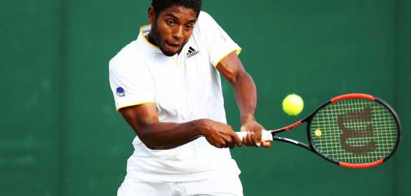 Joao Lucas Reis Da Silva of Brazil plays a backhand in his Boys' Singles first round match on day seven of the Wimbledon Lawn Tennis Championships at All England Lawn Tennis and Croquet Club on July 9, 2018 in London, England.