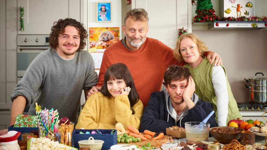 The Brockman family taking a family photo in the kitchen