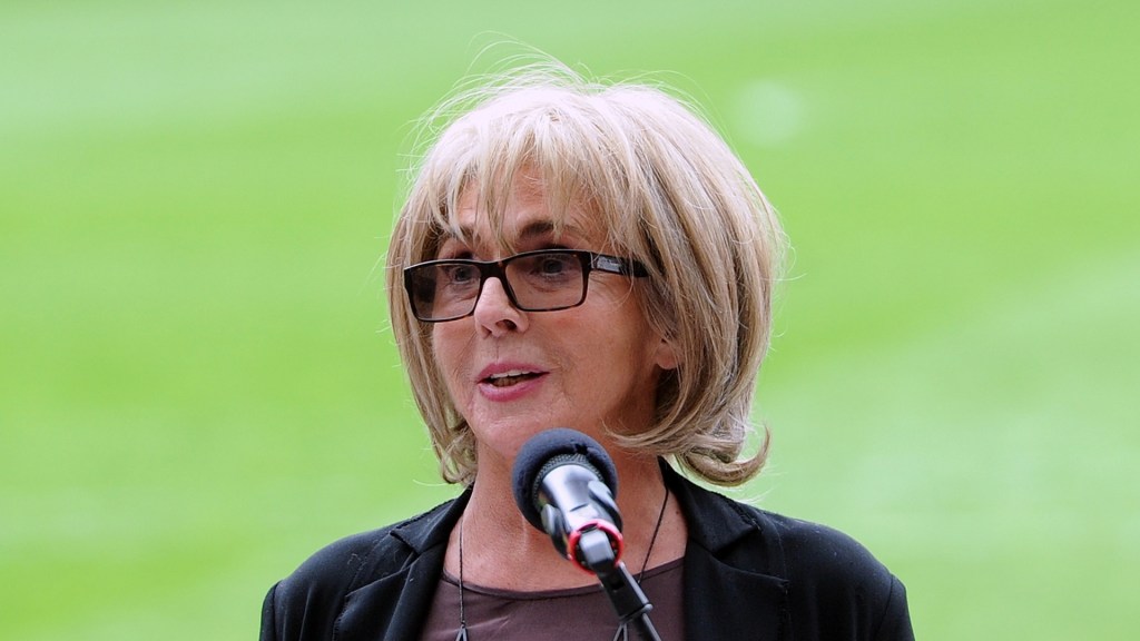 Sue Johnston speaking at a podium