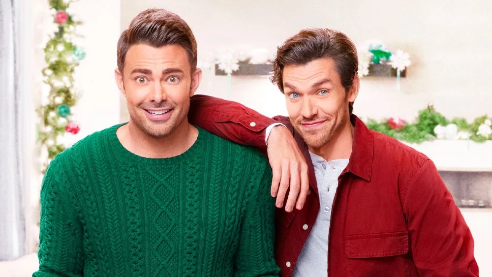 The Holiday Sitter; a man in a green jumper and man in a red jacket looking into camera