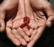 beaded AIDS symbol in hands