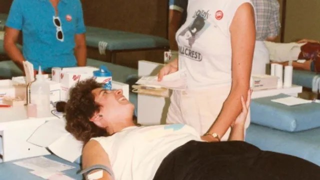 woman giving blood during AIDS crisis