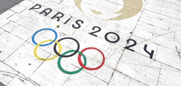 Olympics rings logo and 'Paris 2024' text on the ground