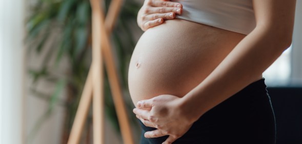 woman with a baby bump after fertility treatments