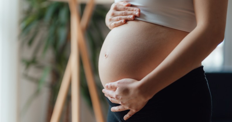 woman with a baby bump after fertility treatments