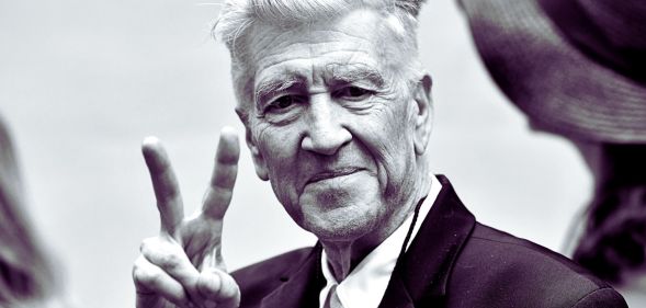 David Lynch throwing a peace symbol.