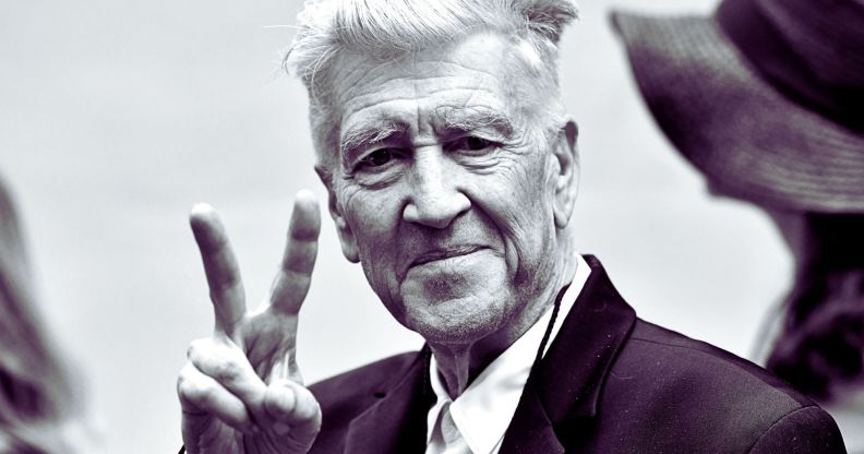 David Lynch throwing a peace symbol.