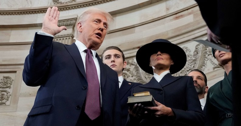 Donald Trump is sworn in as US president by Supreme Court Chief Justice John Roberts during inauguration ceremonies in the Rotunda of the Capitol on January 20, 2025 in Washington, DC, as his wife Melania Trump and son Barron Trump look on. Trump takes office for his second non-consecutive term as the 47th president of the United States. (Photo by Morry Gash / POOL / AFP)