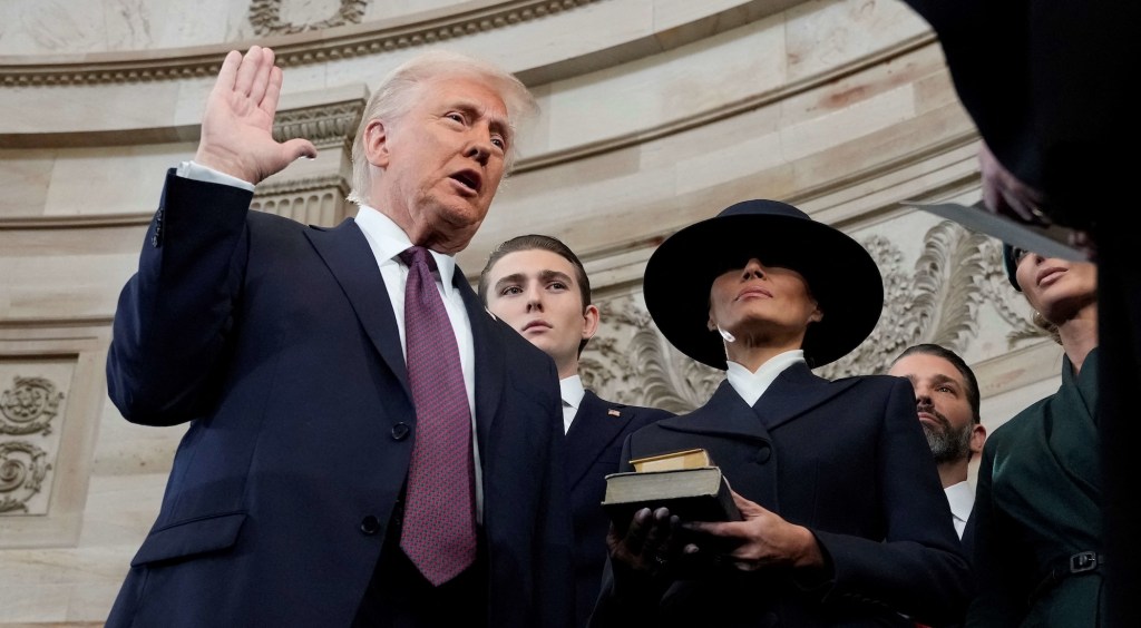 Donald Trump is sworn in as US president by Supreme Court Chief Justice John Roberts during inauguration ceremonies in the Rotunda of the Capitol on January 20, 2025 in Washington, DC, as his wife Melania Trump and son Barron Trump look on. Trump takes office for his second non-consecutive term as the 47th president of the United States. (Photo by Morry Gash / POOL / AFP)