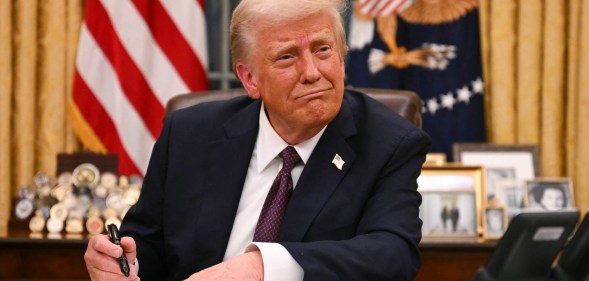 US President Donald Trump signs executive orders in the Oval Office of the White House in Washington, DC, on January 20, 2025. (Photo by Jim WATSON / AFP)