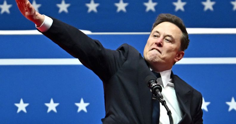 Elon Musk giving a salute to a crowd.