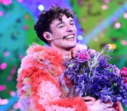 Swiss singer Nemo representing Switzerland with the song "The Code" celebrates on stage after winning the final of the 68th Eurovision Song Contest (ESC) 2024 on May 11, 2024 at the Malmo Arena in Malmo, Sweden. (Photo by Tobias SCHWARZ / AFP)