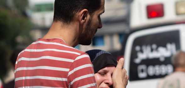 A person comforting a loved one in the Gaza Strip